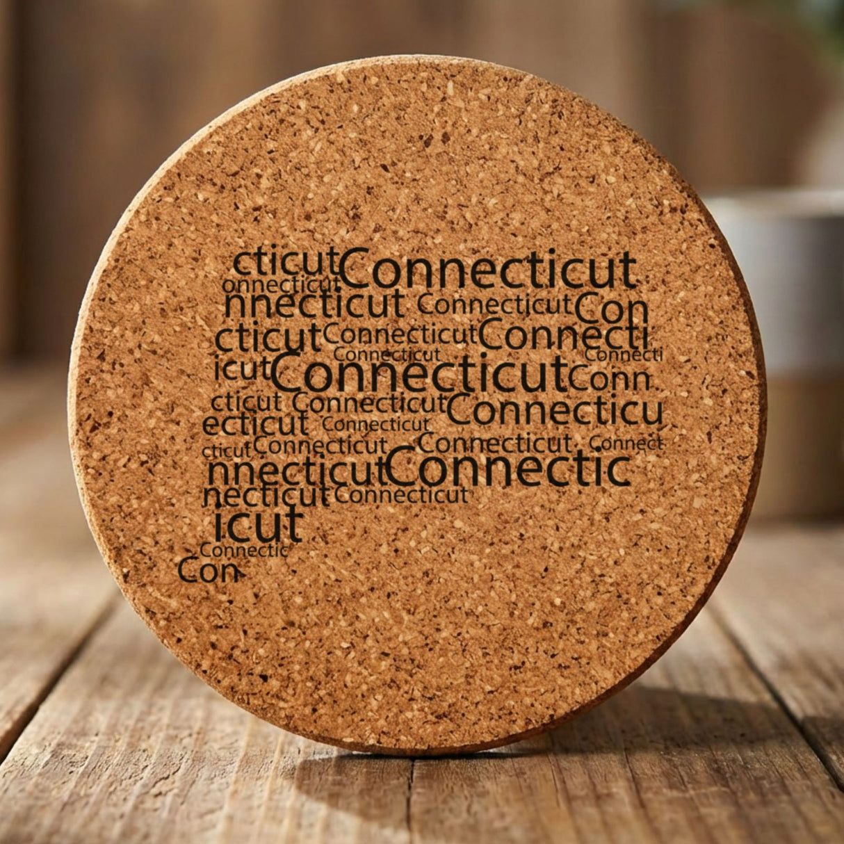Connecticut round cork coaster engraved with a word cloud of repeating Connecticut text