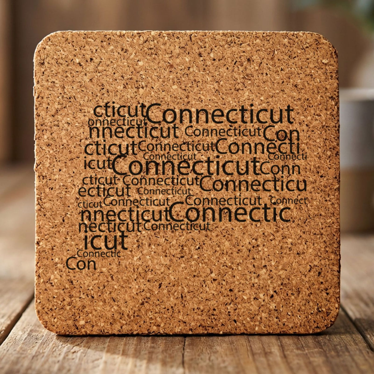 Connecticut square cork coaster engraved with a word cloud of repeating Connecticut text