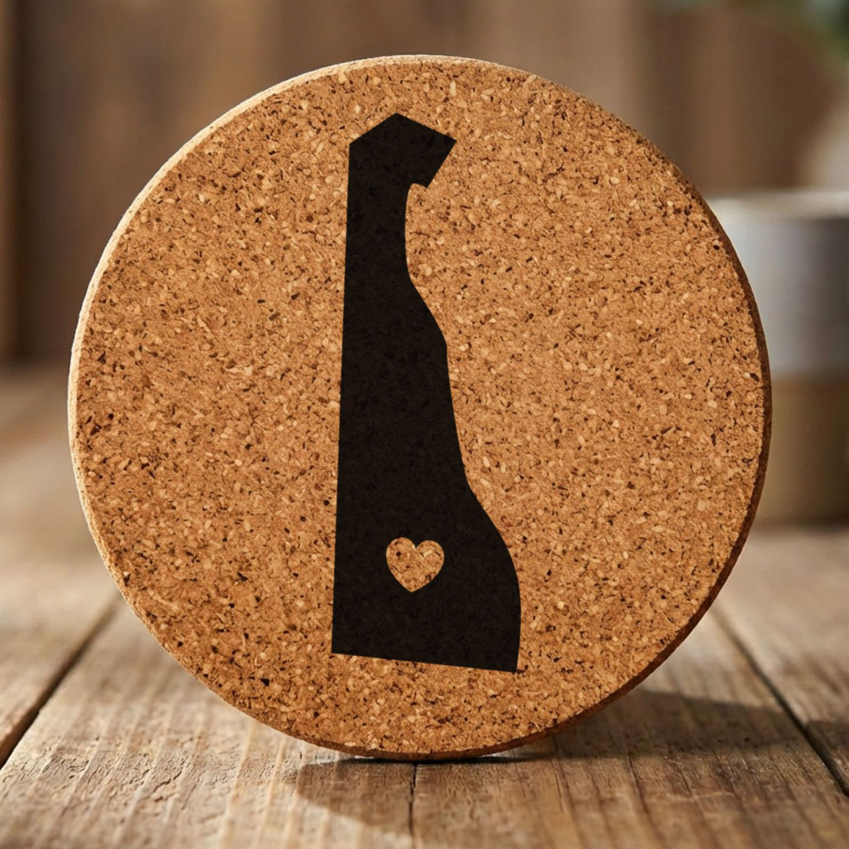 Delaware round cork coaster engraved with the state shape and a heart