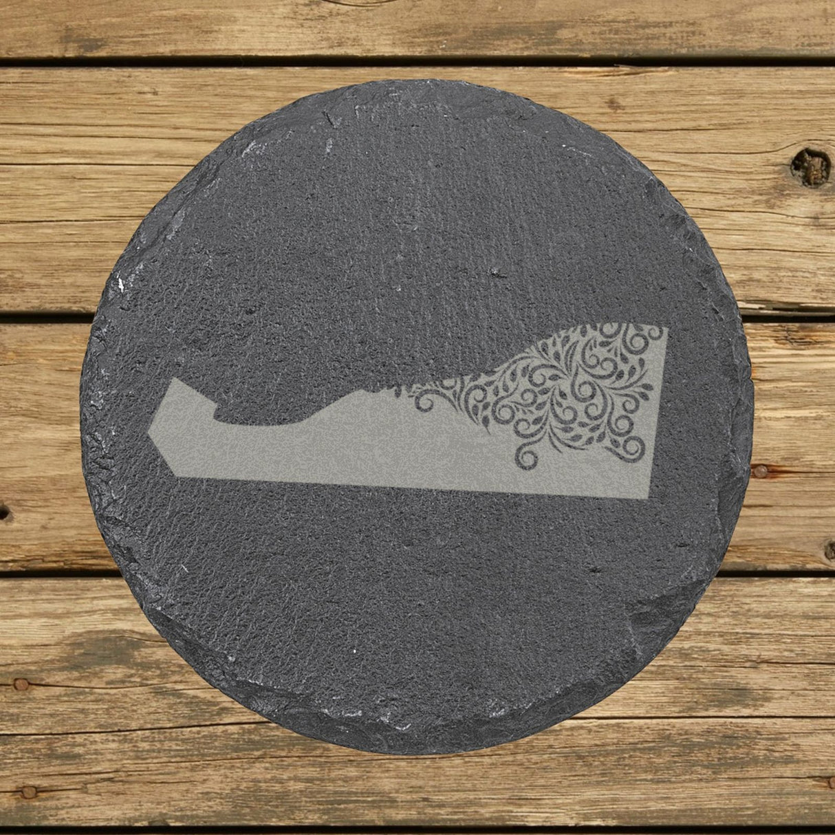 Delaware round slate coaster engraved with the state shape in ornate floral scrollwork