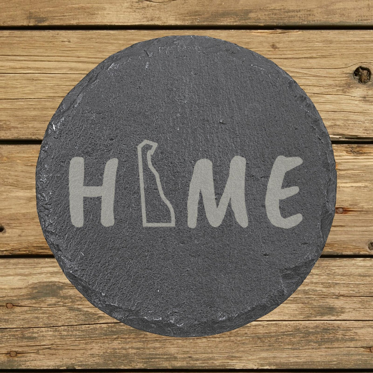 Delaware round slate coaster engraved with HOME using the state outline as the letter O