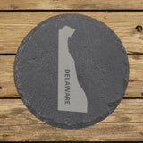 Delaware round slate coaster with the engraved state shape and DELAWARE running vertically