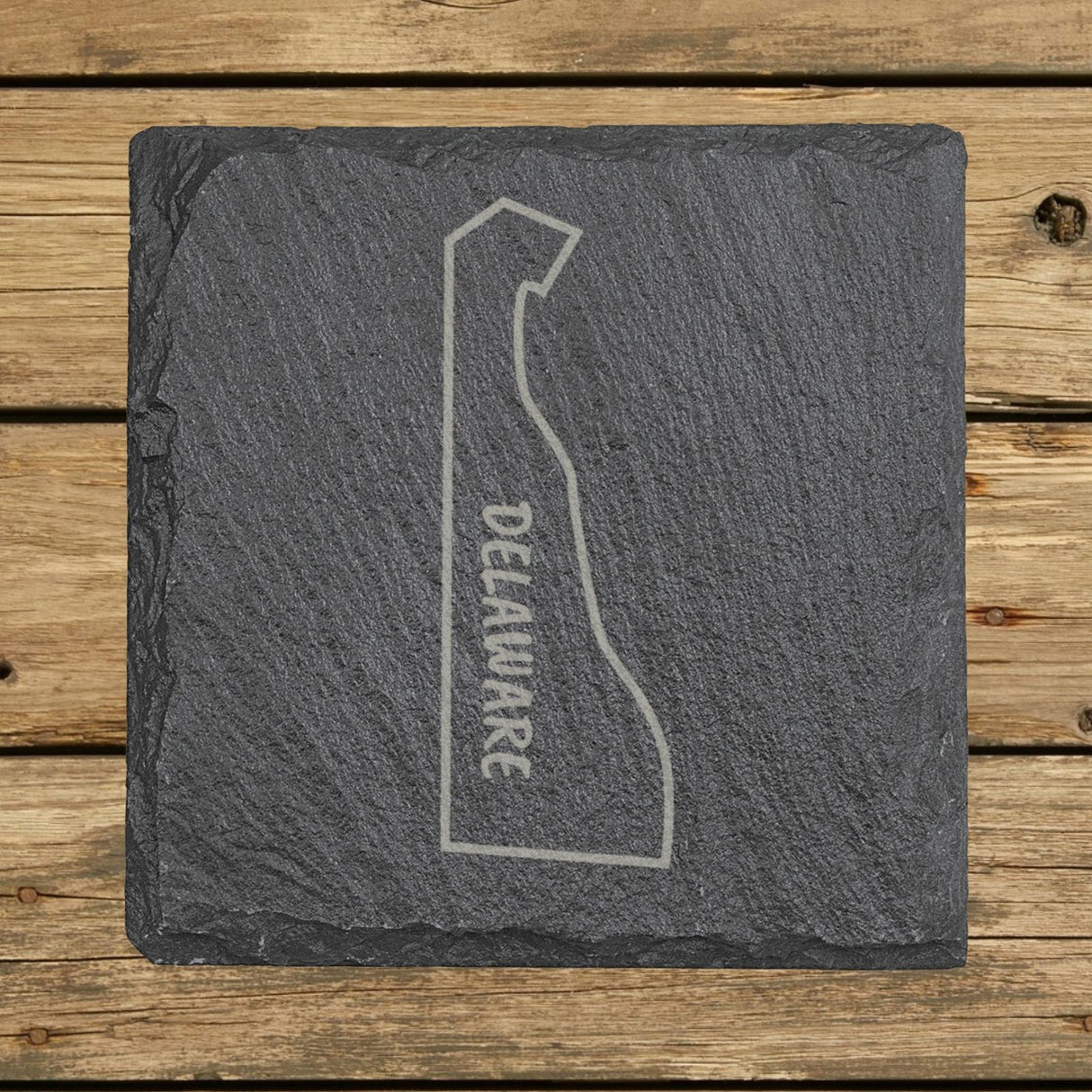 Delaware square slate coaster engraved with the state outline and DELAWARE running vertically