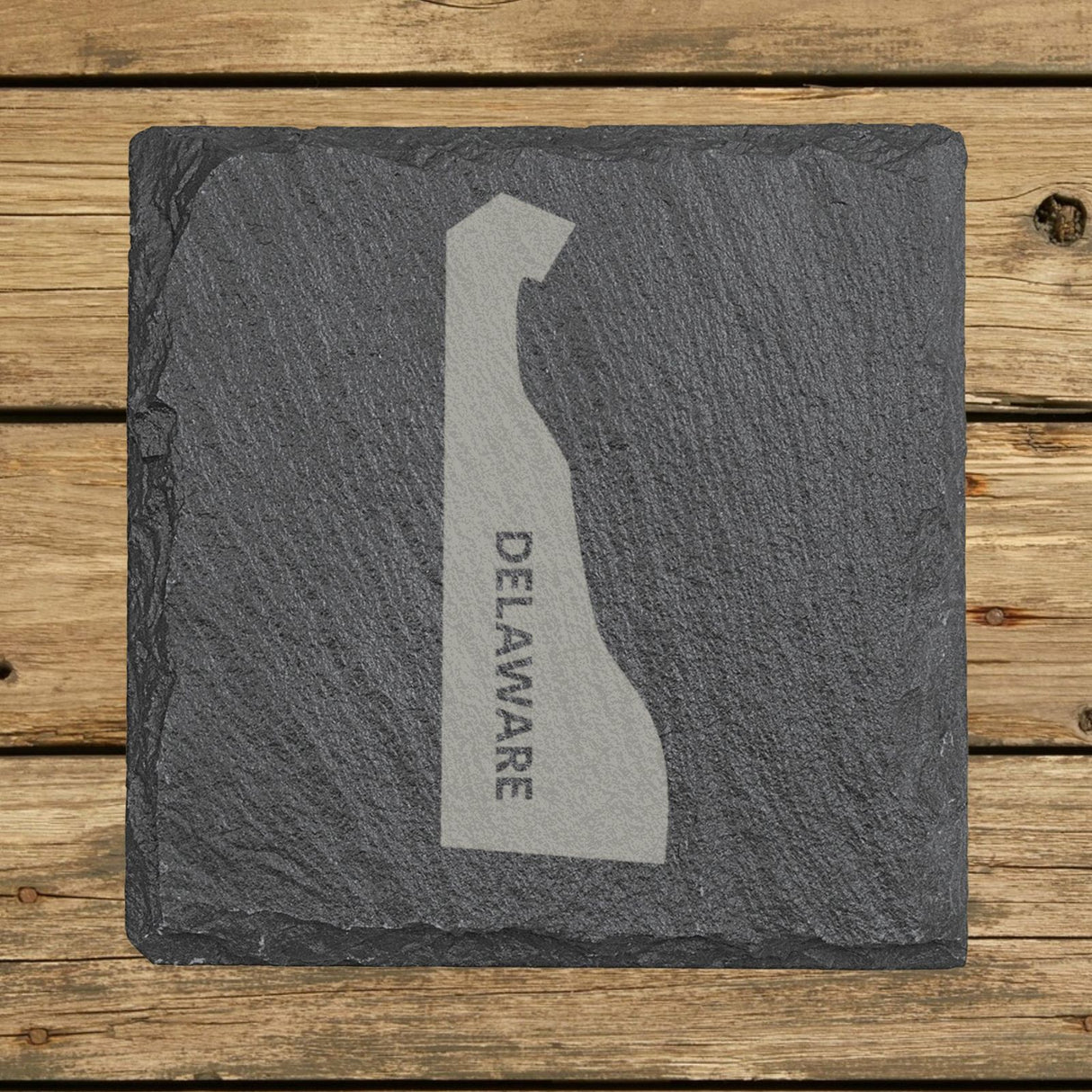 Delaware square slate coaster with the engraved state shape and DELAWARE running vertically