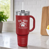 Maroon 40 oz tumbler with handle and straw laser engraved with the Social Club "Dog Mom" design, on a kitchen counter