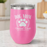 Pink 12 oz stemless wine tumbler laser engraved with the Social Club "Dog Mom" design, on a kitchen counter