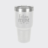 White 30 oz tumbler laser engraved with "Feline Festive"