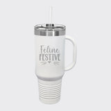 White 40 oz tumbler with handle and straw laser engraved with "Feline Festive"