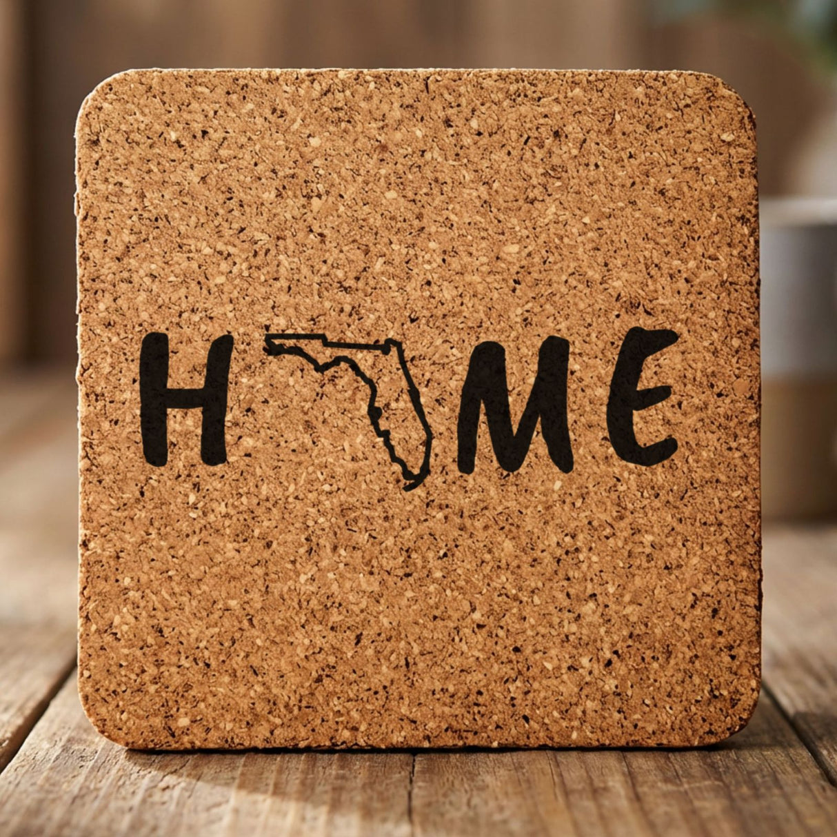 Florida square cork coaster engraved with HOME using the state outline as the letter O