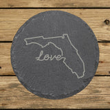 Florida round slate coaster engraved with a hand-drawn state outline and love in cursive
