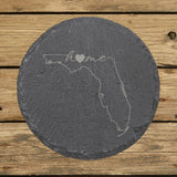 Florida round slate coaster engraved with the state outline and home in script with a heart