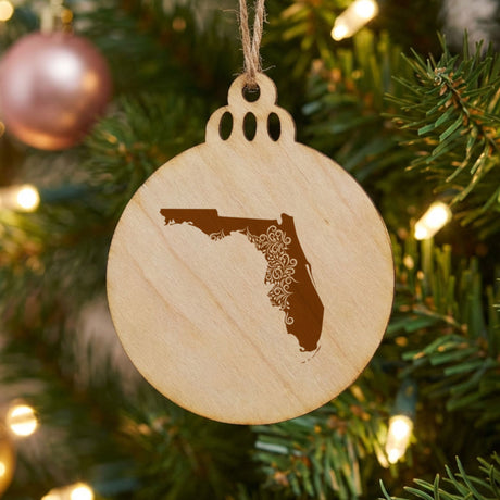 Florida round wood Christmas ornament engraved with the state shape in ornate floral scrollwork