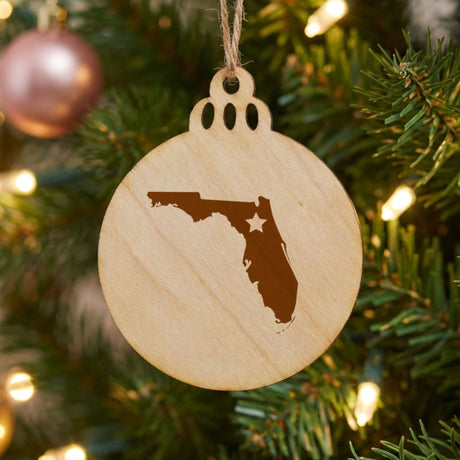 Florida round wood Christmas ornament engraved with the state shape and a star