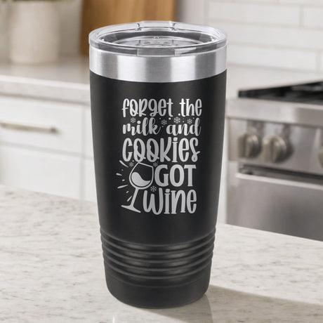 Black 20 oz tumbler laser engraved with "Forget the Milk and Cookies, I've Got Wine", on a kitchen counter