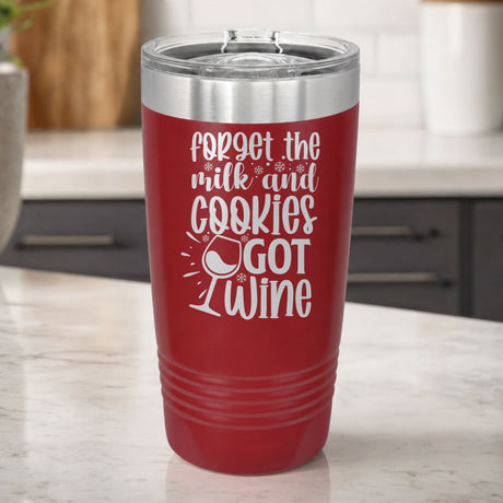 Maroon 20 oz tumbler laser engraved with "Forget the Milk and Cookies, I've Got Wine", on a kitchen counter
