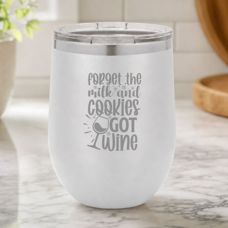 White 12 oz stemless wine tumbler laser engraved with "Forget the Milk and Cookies, I've Got Wine", on a kitchen counter