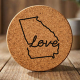 Georgia round cork coaster engraved with a hand-drawn state outline and love in cursive