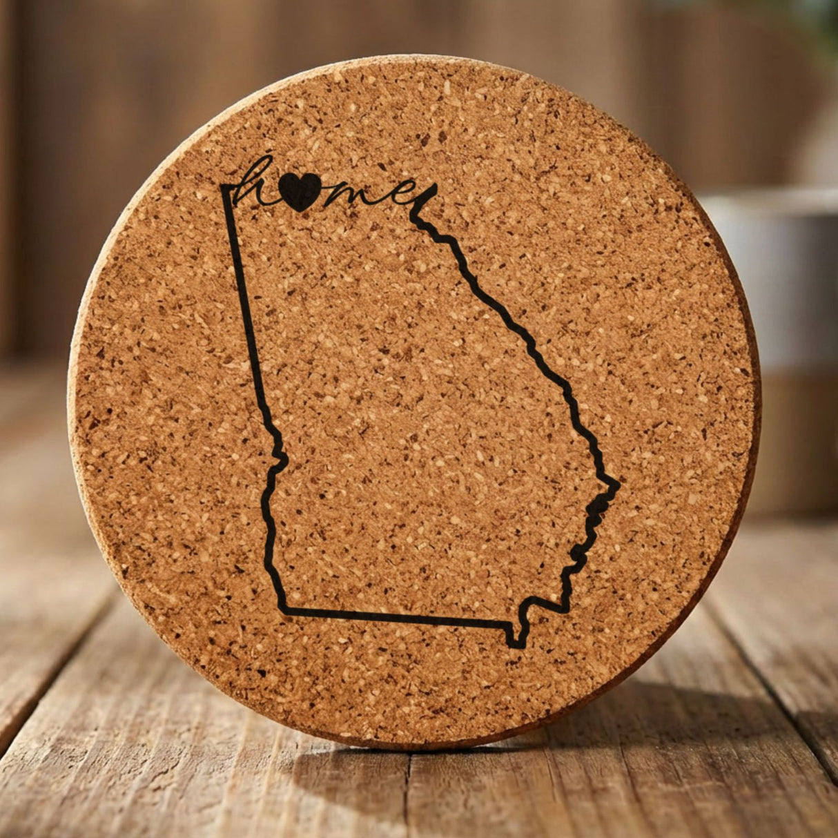 Georgia round cork coaster engraved with the state outline and home in script with a heart