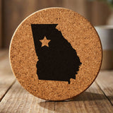 Georgia round cork coaster engraved with the state shape and a star