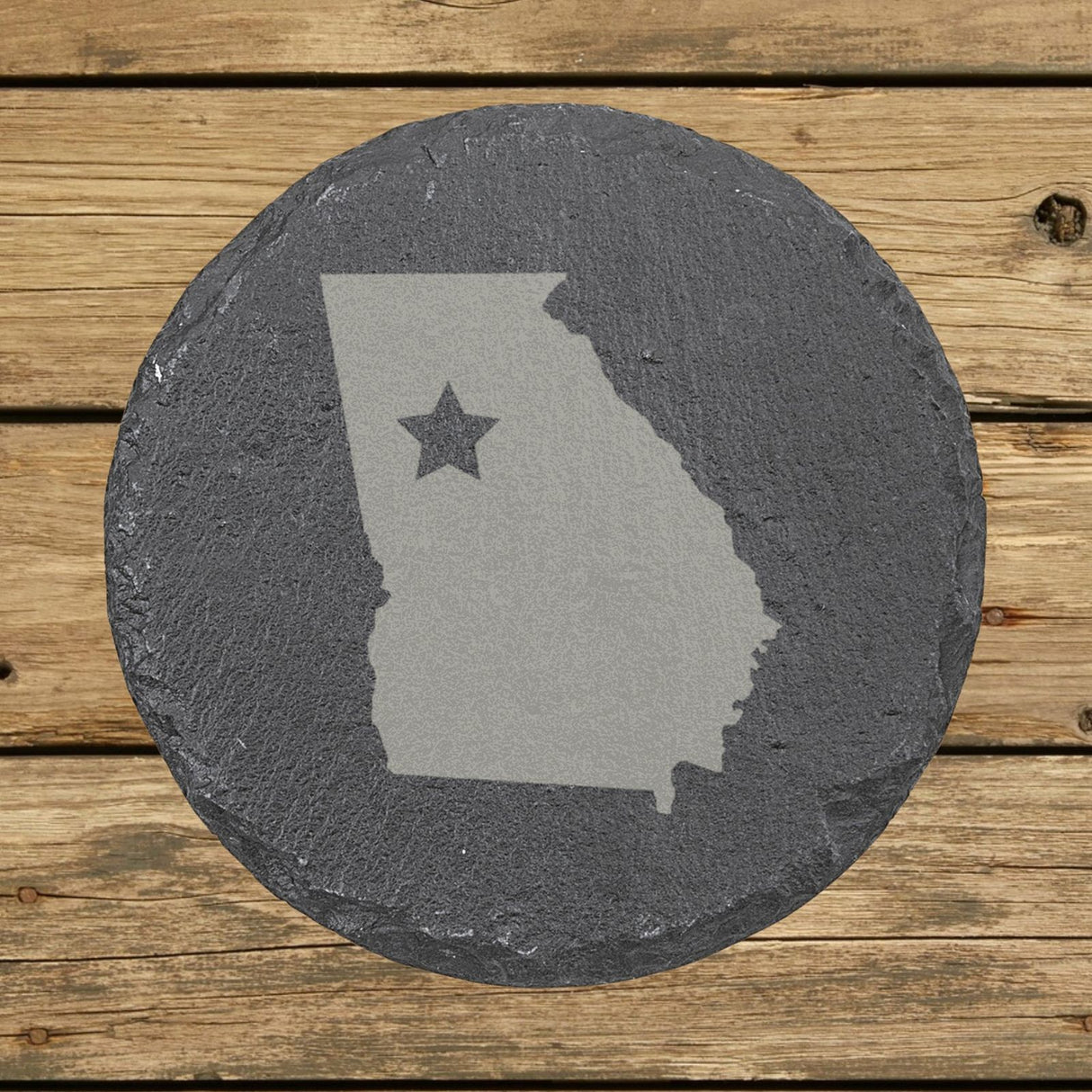 Georgia round slate coaster engraved with the state shape and a star