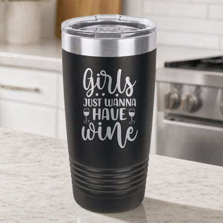 Black 20 oz tumbler laser engraved with "Girls Just Wanna Have Wine", on a kitchen counter
