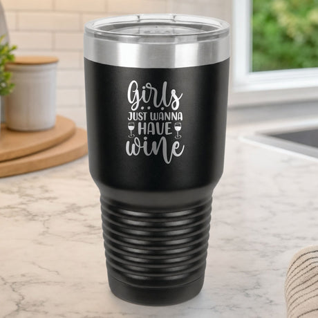 Black 30 oz tumbler laser engraved with "Girls Just Wanna Have Wine", on a kitchen counter