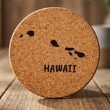 Hawaii round cork coaster engraved with the state outline and HAWAII in hand-drawn brush lettering