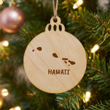 Hawaii round wood Christmas ornament engraved with the state outline and HAWAII in hand-drawn brush lettering