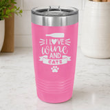 Pink 20 oz tumbler laser engraved with "I Love Wine and Cats", a wine bottle, a heart and a paw print, on a kitchen counter