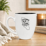 White 16 oz ceramic coffee mug printed with the California state outline and The Golden State