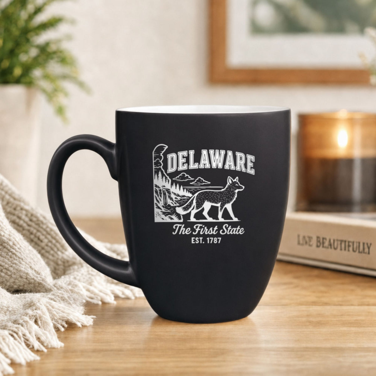 Black 16 oz ceramic coffee mug printed with the Delaware state outline and The First State