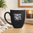 Black 16 oz ceramic coffee mug printed with the Montana state outline and The Treasure State