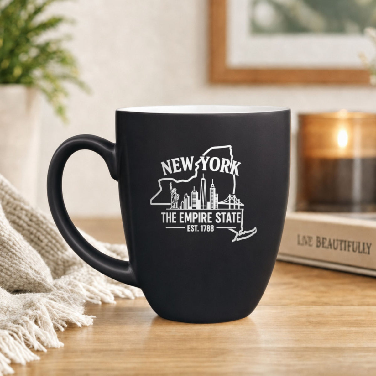 Black 16 oz ceramic coffee mug printed with the New York state outline and The Empire State
