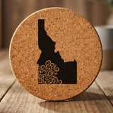 Idaho round cork coaster engraved with the state shape in ornate floral scrollwork