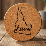 Idaho round cork coaster engraved with a hand-drawn state outline and love in cursive