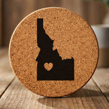 Idaho round cork coaster engraved with the state shape and a heart