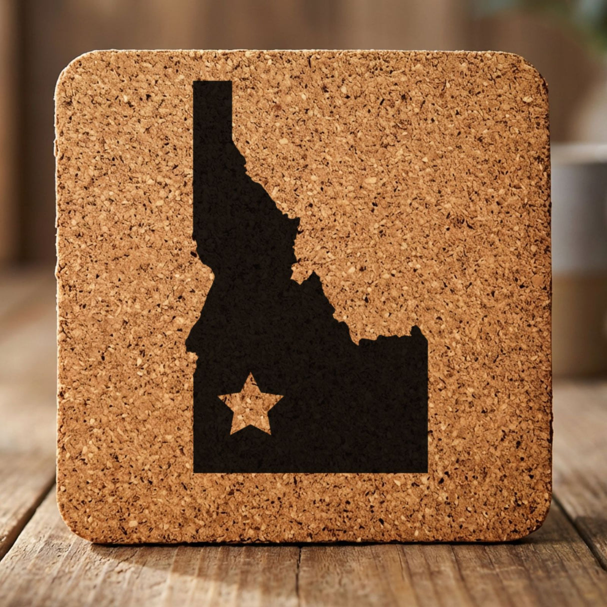 Idaho square cork coaster engraved with the state shape and a star