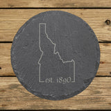 Idaho round slate coaster engraved with the state outline and est. 1890