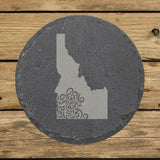 Idaho round slate coaster engraved with the state shape in ornate floral scrollwork