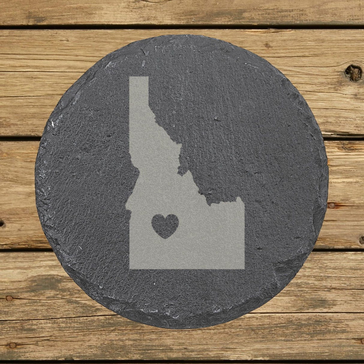 Idaho round slate coaster engraved with the state shape and a heart