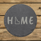 Idaho round slate coaster engraved with HOME using the state outline as the letter O
