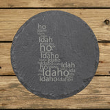 Idaho round slate coaster engraved with a word cloud of repeating Idaho text