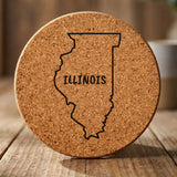 Illinois round cork coaster engraved with the state outline and ILLINOIS in hand-drawn brush lettering