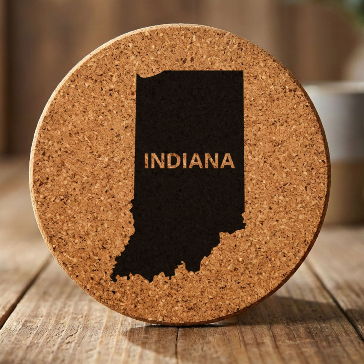 Indiana round cork coaster engraved with the state shape and INDIANA in bold lettering