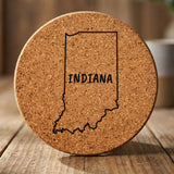 Indiana round cork coaster engraved with the state outline and INDIANA in hand-drawn brush lettering