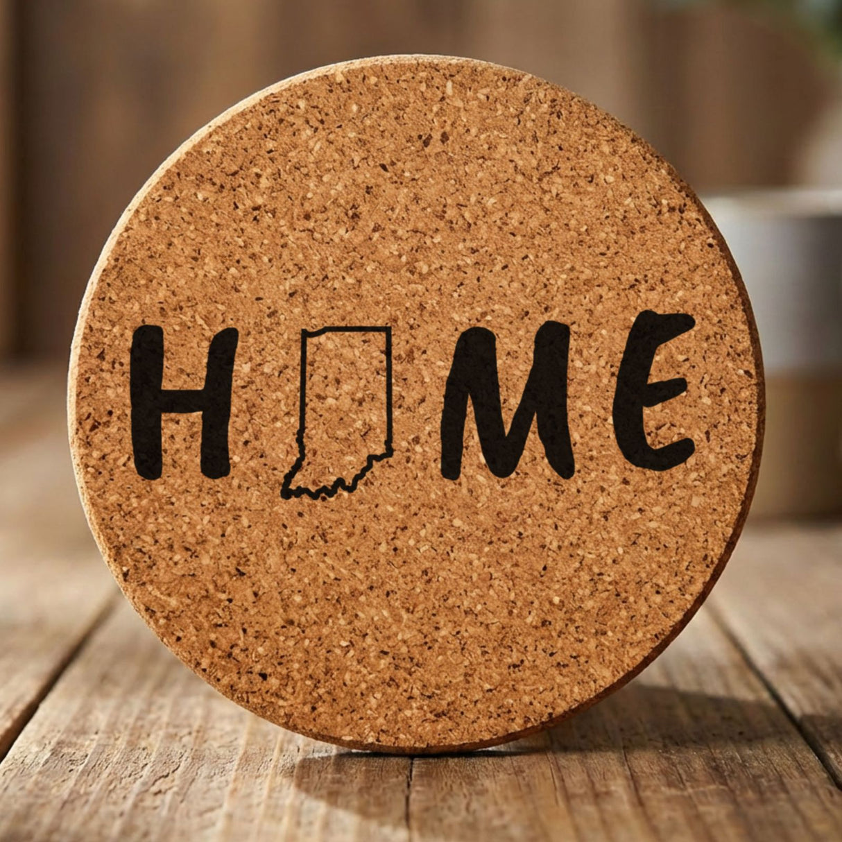 Indiana round cork coaster engraved with HOME using the state outline as the letter O