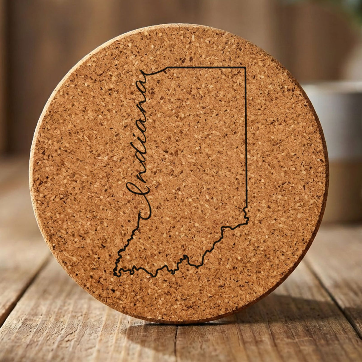 Indiana round cork coaster engraved with the state outline and Indiana in script lettering