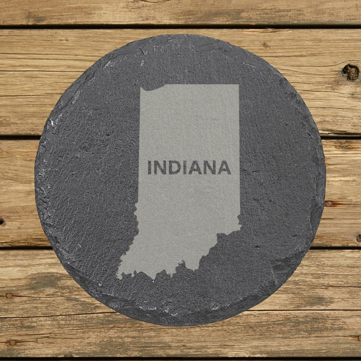 Indiana round slate coaster engraved with the state shape and INDIANA in bold lettering