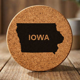 Iowa round cork coaster engraved with the state shape and IOWA in bold lettering