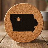 Iowa round cork coaster engraved with the state shape and a star